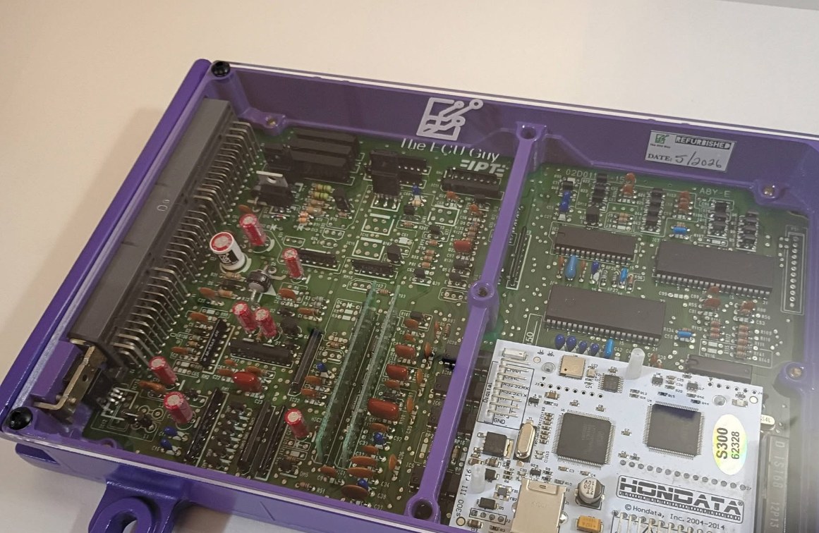A refurbished Honda ECU in a candy purple The ECU Guy case with a Hondata S300 installed