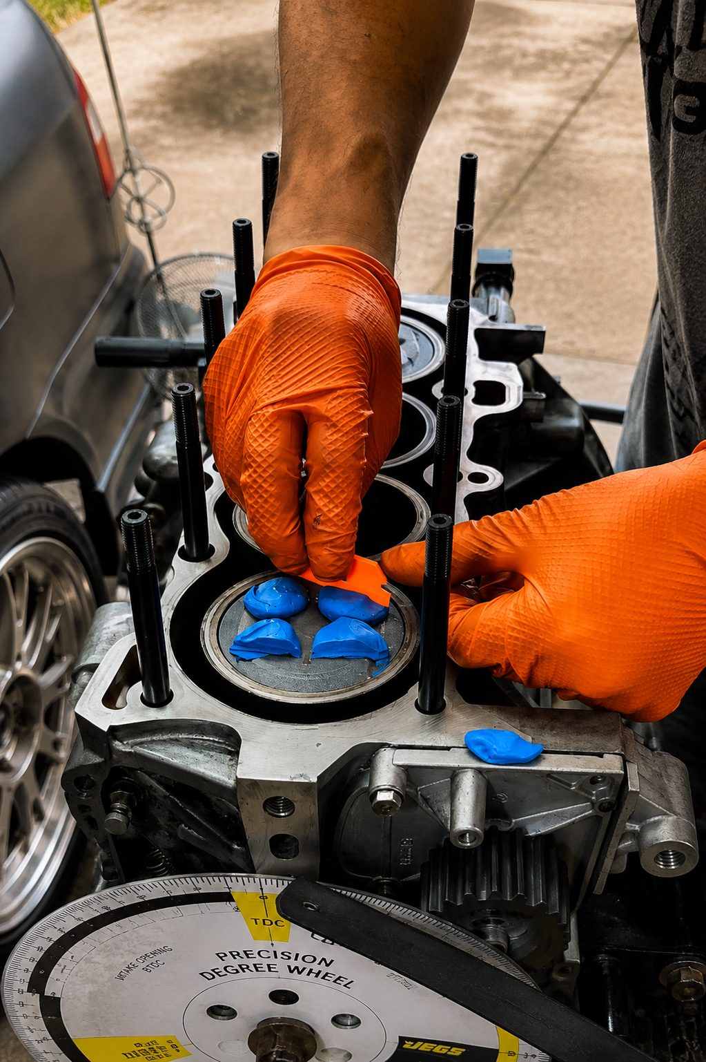 Blue clay pressed onto the piston crowns with the degree wheel mounted