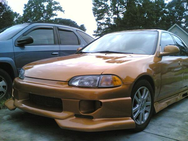 The early-2000s Civic build from the side — gold paint, molded kit