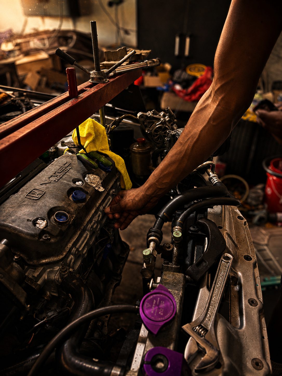 The D15B coming out on the red hoist, valve cover still wearing its Honda mark