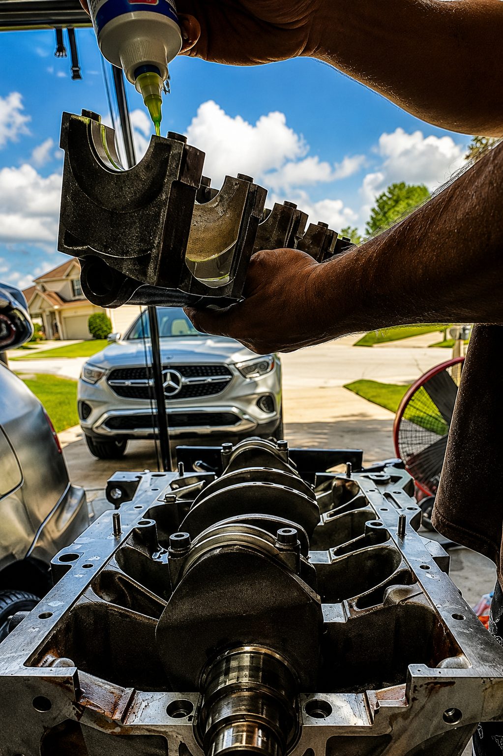 Assembly lube going onto a main cap held over the crank