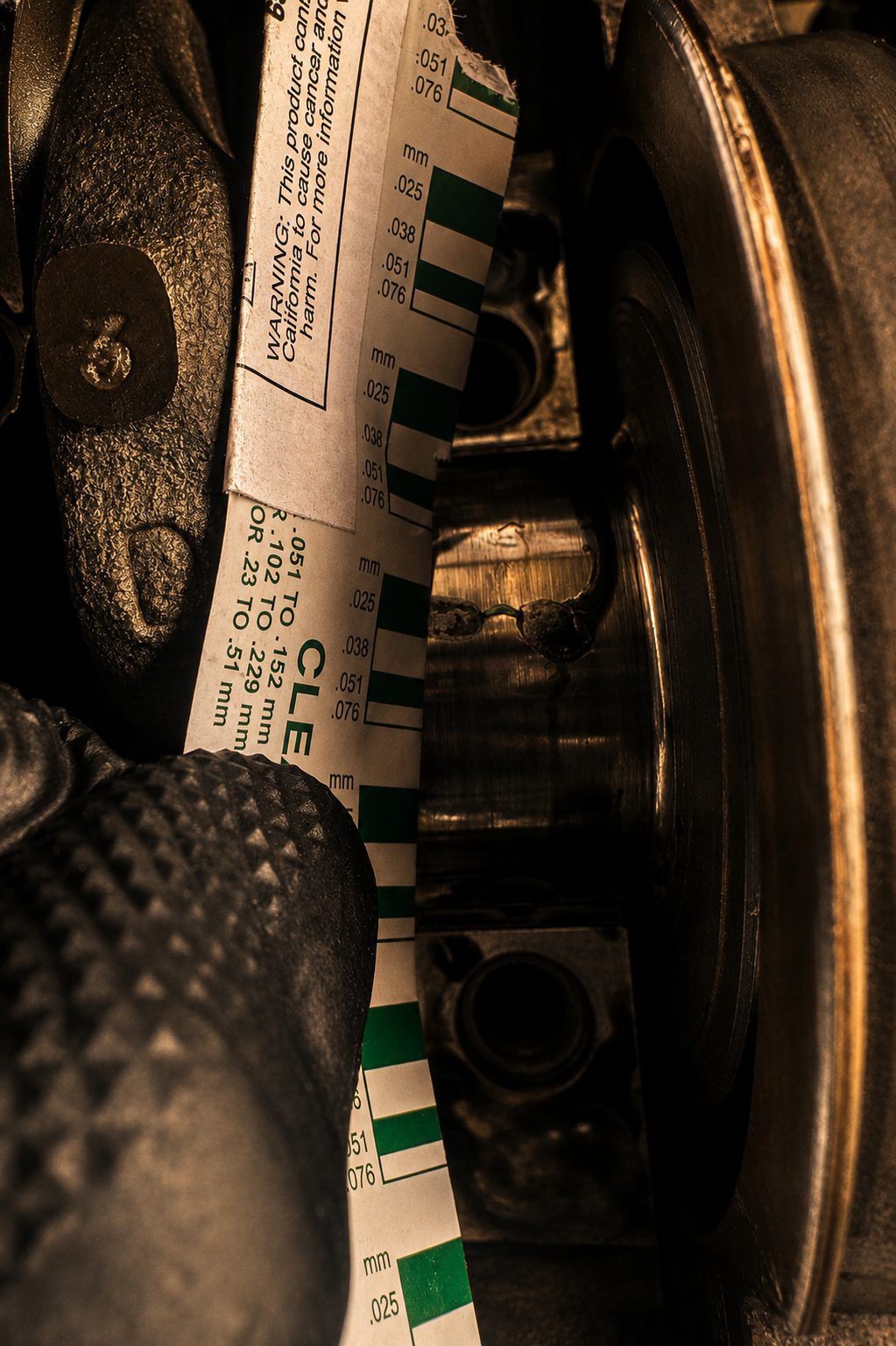 Plastigage strip laid across a journal, measuring oil clearance