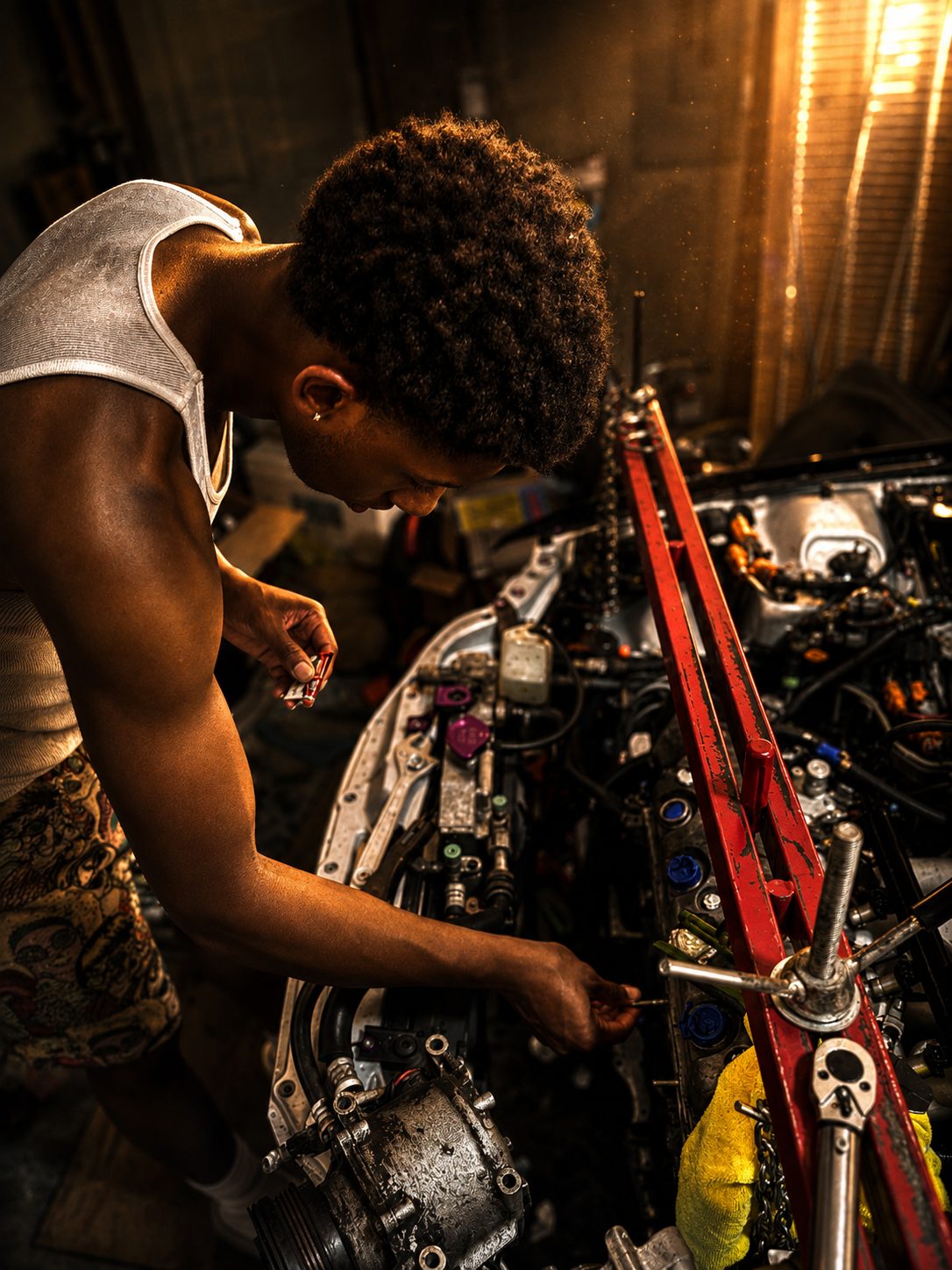 His son working the block down to bare metal on the hoist